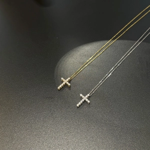 Close-up of gold and silver S925 sterling silver cross pendants with cubic zirconia