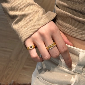 Close-up of vintage gold S925 silver rings with tiger eye stone and wheat ear engraving