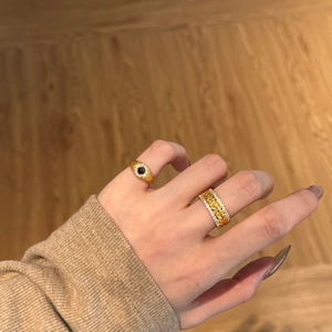 Detail of S925 silver gold rings featuring an eye-shaped stone and wheat pattern band