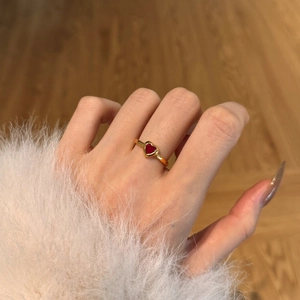 Model wearing a gold heart-shaped ruby ring with a vintage French court style design