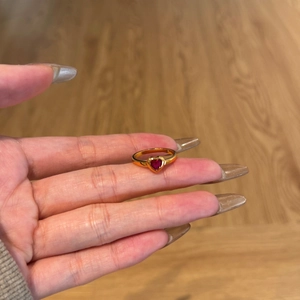Close-up of heart-shaped red zircon gold ring with brushed S925 silver finish