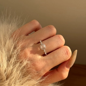 S925 sterling silver ring with square pink stone and halo diamonds on finger