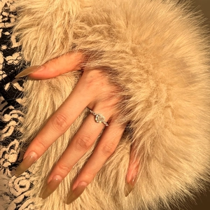 Detail of S925 sterling silver ring with sparkling round zircon on a luxury background