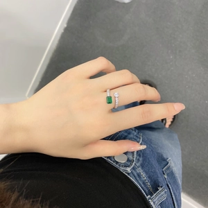 Detailed view of S925 silver ring featuring emerald cut green stone and square zircon