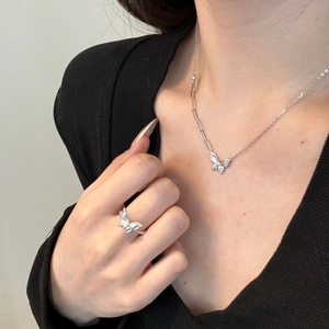 Detailopname van S925 zilveren vlinder sieradenset met ketting en ring op een model