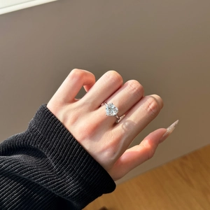 Close-up of heart-shaped diamond ring in S925 silver on hand with elegant lighting