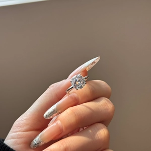 Macro shot of S925 sterling silver ring with a sparkling round-cut four-prong solitaire