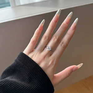 Detailed view of an S925 silver heart-cut solitaire ring worn on a woman's finger