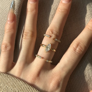Macro view of a 3-piece gold ring set featuring a marquise-cut stone and open diamond bands