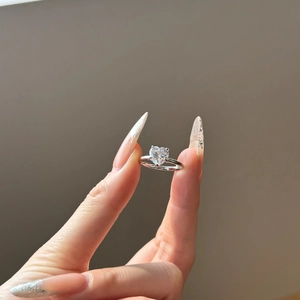 Detail of a heart-shaped diamond engagement ring in S925 sterling silver with claw setting