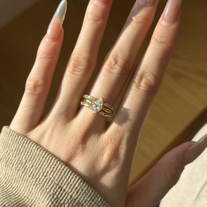 Close-up of stacked S925 silver rings with marquise cut center stone in gold finish