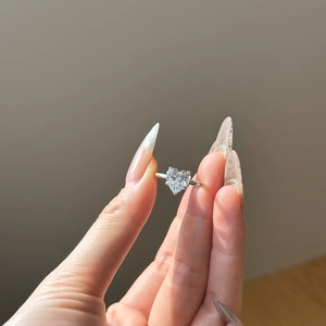 Detail of S925 sterling silver ring featuring a large heart-cut sparkling gemstone