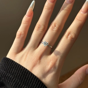 Close-up of a heart-cut cubic zirconia stone on a slim 925 sterling silver ring