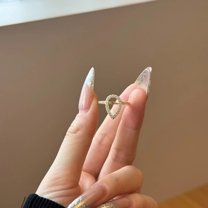 Detailed view of a gold-plated S925 sterling silver hollow pear-shaped ring with micro-pave stones