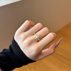 Detailed view of a gold-plated teardrop cut ring featuring pavé-set sparkling cubic zirconia