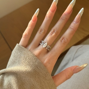 Close-up of three-piece S925 silver ring set with marquise cut stone on a model hand