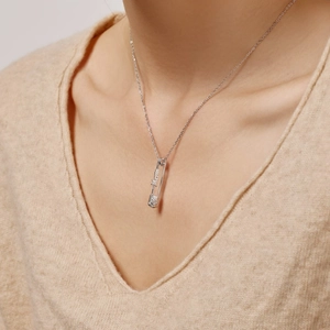 Detail of S925 sterling silver Mom safety pin necklace with a clear cubic zirconia stone