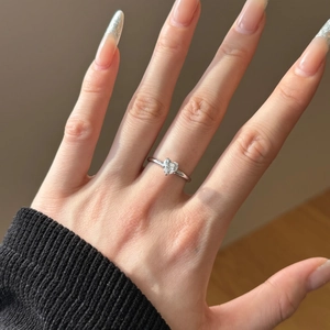 Close-up of heart-shaped diamond ring in S925 sterling silver on a woman's finger