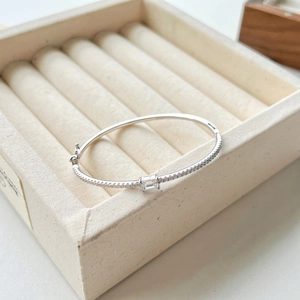 Detail of S925 silver bracelet featuring emerald-cut cubic zirconia and pavé setting