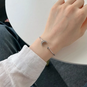 On-wrist view of S925 sterling silver moon and heart open bangle with zircon inlay