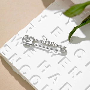 Close-up of S925 sterling silver Mom brooch with heart-shaped zircon on a pin design
