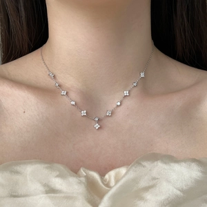 Elegant S925 sterling silver necklace with delicate zircon four-leaf clover charms on model