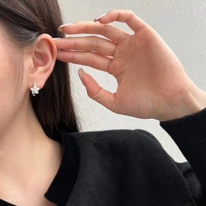 Elegant S925 sterling silver flower earrings with zircon pavé on female model