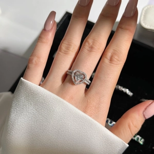 Close-up of S925 silver ring featuring heart-cut zircon and micro-pave double band
