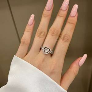 Close-up of S925 sterling silver heart-shaped stackable rings set with sparkling zircons