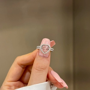 Close-up of S925 silver ring featuring a heart-shaped pink gemstone and pavé diamonds