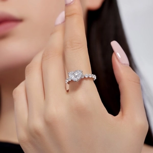 Macro detail of a heart-shaped 8A diamond ring with micro-pave silver band