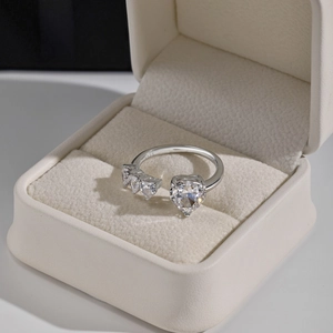 Macro shot of S925 sterling silver ring showing heart-cut zircon and silver engraving
