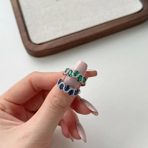 Elegant wave-shaped S925 silver ring with blue and green zircon stones in pave setting