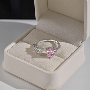 Macro shot of S925 sterling silver ring featuring pink heart-cut gemstone in a velvet box