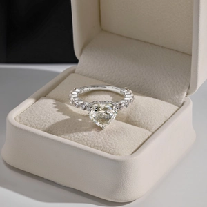 Macro shot of S925 sterling silver ring with large heart-shaped stone and side diamonds