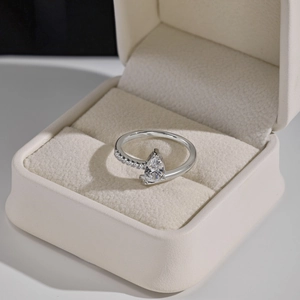 Detail of pear-cut zircon on S925 sterling silver ring in cream velvet jewelry box