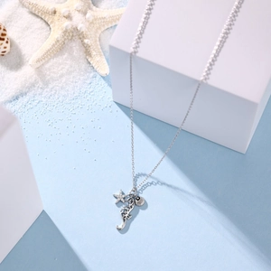 Detailed macro of S925 silver necklace featuring starfish, seahorse and shell charms
