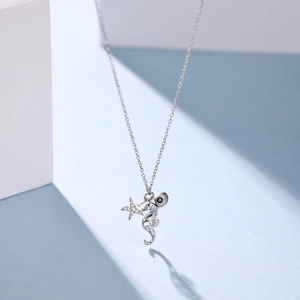 Detail of S925 sterling silver seahorse necklace with micro-pave cubic zirconia charms