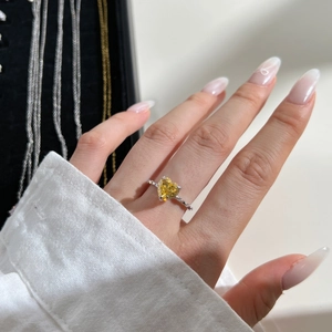 Gros plan sur bague en argent avec zircon jaune en cœur et diamants micropavés