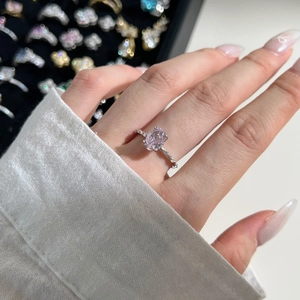 Detailed view of an oval pink ice cut zircon ring set in S925 sterling silver with diamonds
