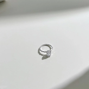 Macro shot of oval-cut zircon center stone with small gems on S925 silver band