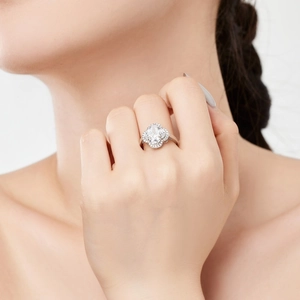 Macro shot of S925 silver clover ring with sparkling zircon stones on a model's hand