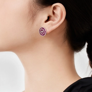 Close-up of model wearing luxury S925 silver round stud earrings with red zircon accents