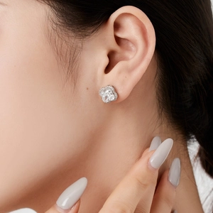 Close-up of S925 sterling silver clover earrings with zircon stones on a model