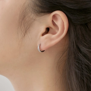 Classic S925 sterling silver hoop earrings with curved zircon inlay on a female model