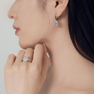 Close-up of S925 silver earrings and ring with radiant cut square zircon stones
