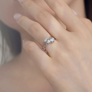 Close-up of Toi et Moi S925 silver ring featuring pear and round cut stones on hand