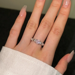 Close-up of S925 silver ring featuring a pink round stone and zircon-encrusted band