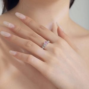Close-up of S925 silver ring with pink ice-cut zircon and pave diamond setting