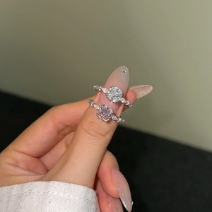 Detail of S925 silver rings with square zircon stones in white and pink hues